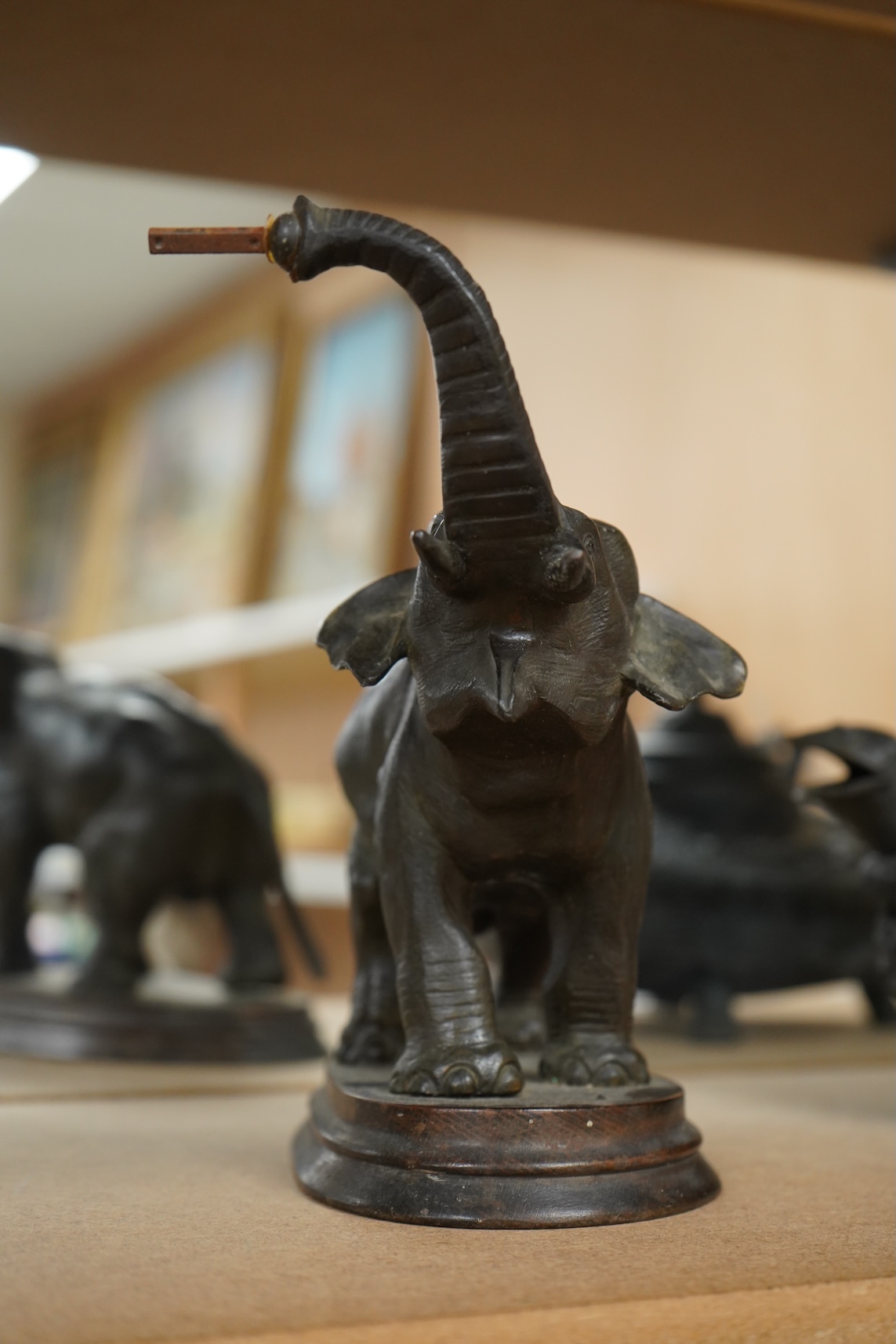 A bronzed metal model of an elephant and a bronze model of a greyhound, tallest 20cm